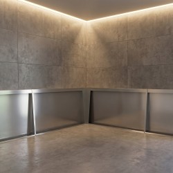 Stainless steel corner trim for aesthetic and hygienic urinal stall finish