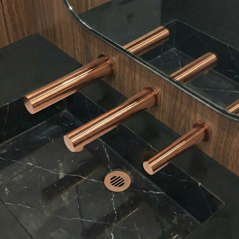 RONDEO designer touch-free soap dispenser in copper PVD with matching tap and hand dryer