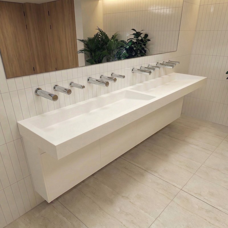 Automatic wall-mounted hand dryer above the sink, with a design matching the RONDEO water and soap spouts